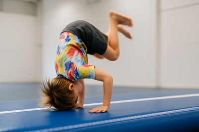 child doing forward roll on airtrack. realistic